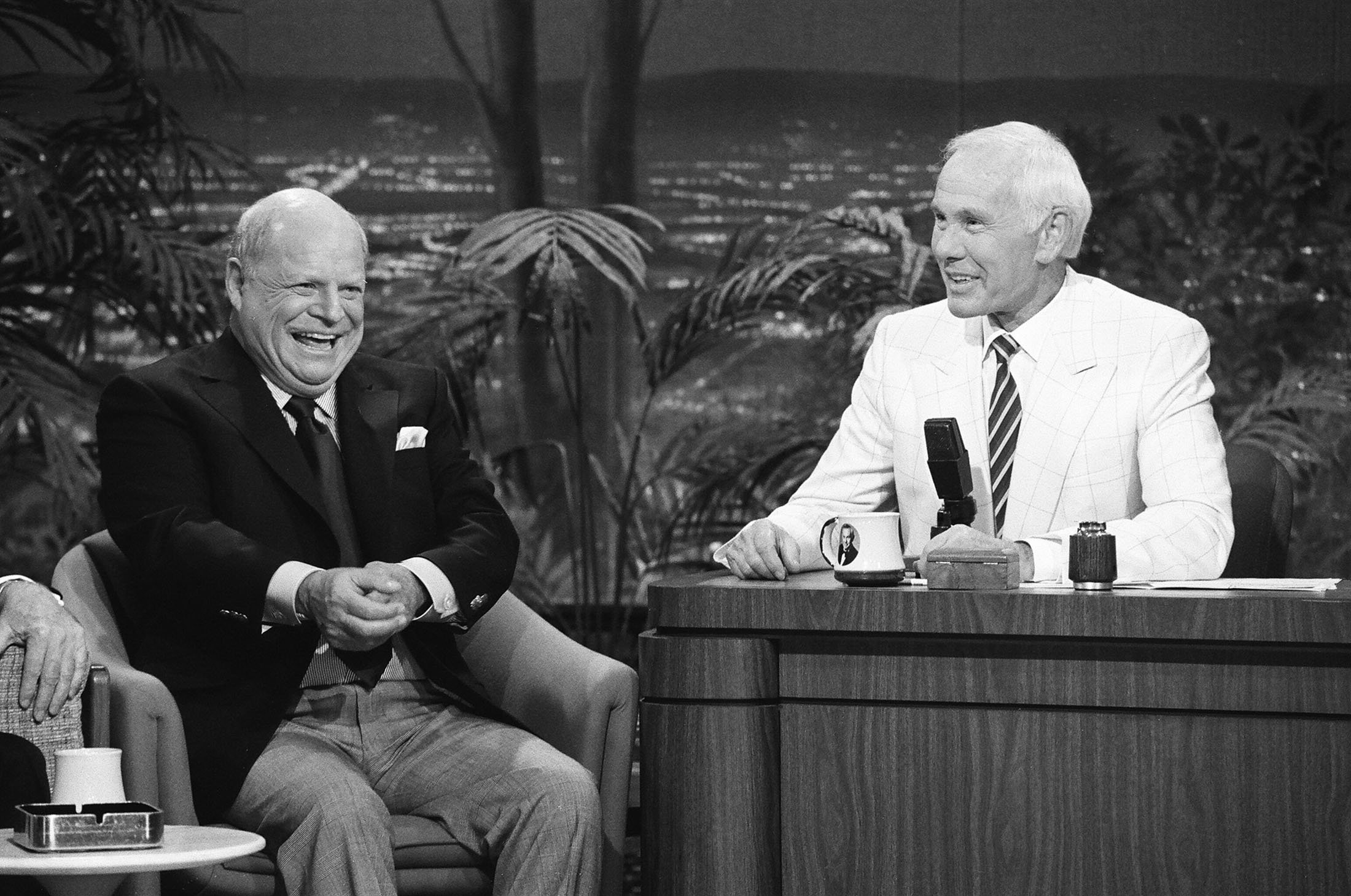 Comedian Don Rickles (L) laughs during an interview with host Johnny Carson on 'The Tonight Show Starring Johnny Carson,' in New York, U.S., May 31, 1991. (Getty Images)