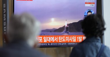 People watch a TV screen showing a news program reporting about North Korea's missile launch with file footage at a train station in Seoul, South Korea, Oct. 19, 2021. (AP Photo)