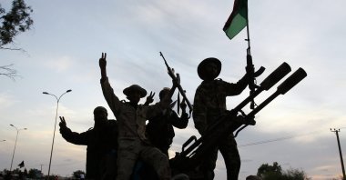 Libyan revolutionary fighters returning from Sirte are welcomed at Al Guwarsha gate in Benghazi, Libya, Oct. 22, 2011. (AP Photo)