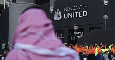 A man wearing a Saudi Arabian headdress passes the St. James' Park in Newcastle, England, Oct. 17, 2021. (AP Photo)