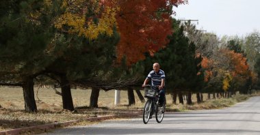 Eyüp Nizam rides a bicycle on a street, Konya, Turkey, Oct. 19, 2021. (AA Photo)