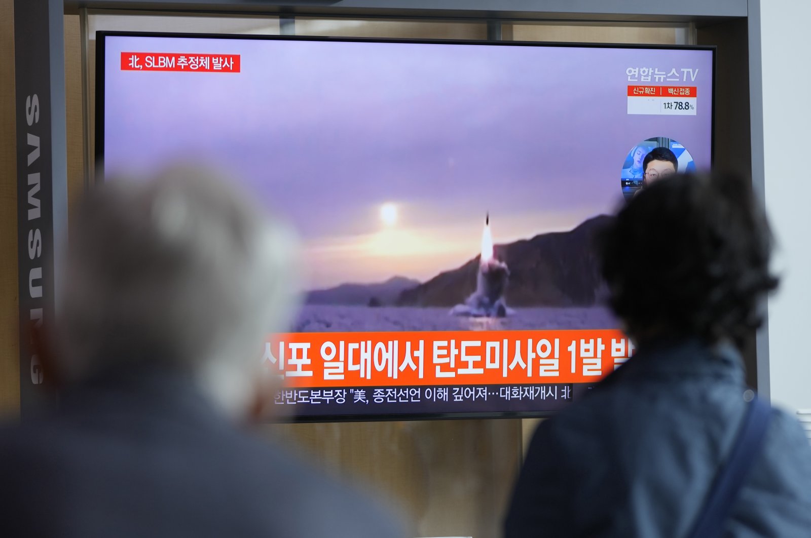 People watch a TV screen showing a news program reporting about North Korea's missile launch with file footage at a train station in Seoul, South Korea, Oct. 19, 2021. (AP Photo)