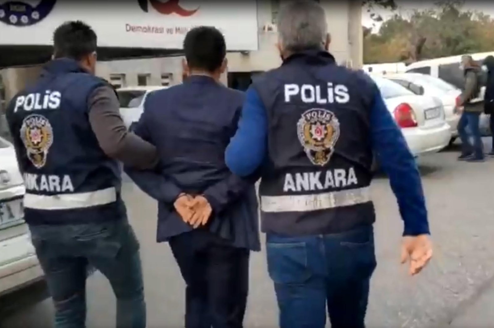 A suspect seen with police in capital Ankara, Turkey, Oct. 19, 2021. (DHA Photo)