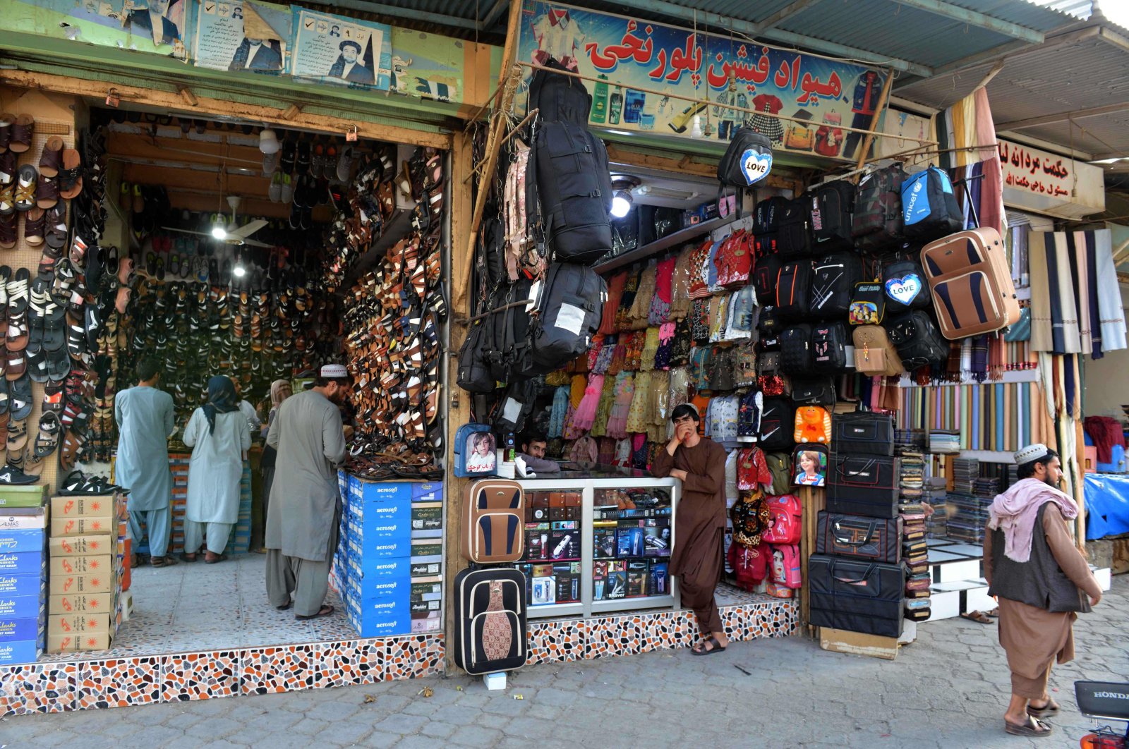 Vendors (C) wait for customers at their shop in Kandahar, Afghanistan, Oct. 9, 2021. (AFP Photo)