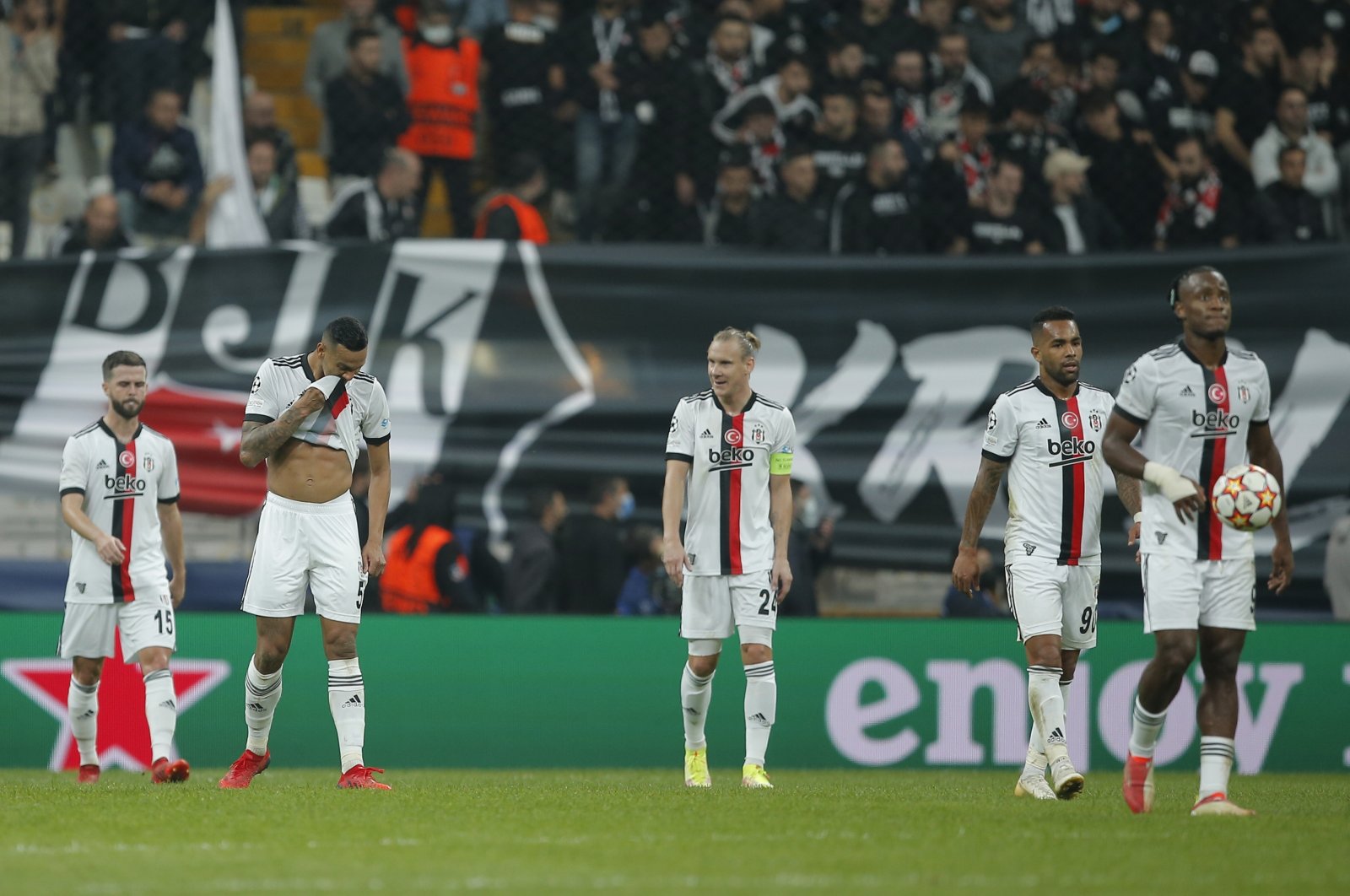 Beşiktaş players walk along the pitch after Sporting CP scored its third goal during Champions League group C football match between Beşiktaş and Sporting CP at the Vodafone Park Stadium in Istanbul, Turkey, Oct. 19, 2021. (AP Photo)