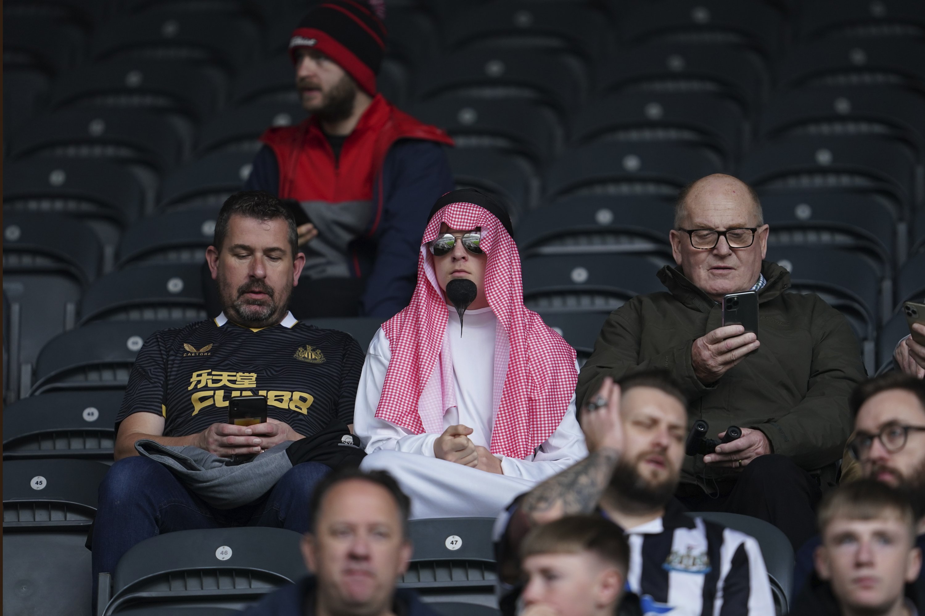 Newcastle fans wait for the start of an English Premier League match between Newcastle and Tottenham Hotspur at St. James' Park in Newcastle, England, Oct. 17, 2021. (AP Photo)