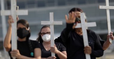 Demonstrators hold crosses during a protest to pay tribute to Brazil's 600,000 COVID-19 deaths and against Brazil's President Jair Bolsonaro's handling of the coronavirus disease pandemic, in Brasilia, Brazil, Oct. 8, 2021. (Reuters Photo)