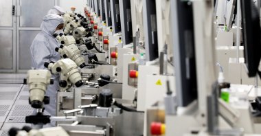 Workers monitor operations at the chip packaging firm Unisem Berhad plant in Ipoh, Malaysia, Oct. 15, 2021. (Reuters Photo)