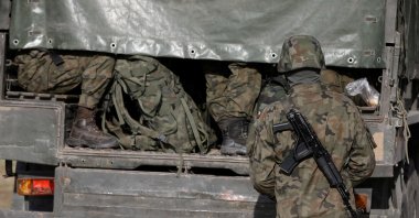 Polish army soldiers are seen in front of the border guard headquarters in Michalowo, Poland, Oct. 11, 2021. (Reuters Photo)