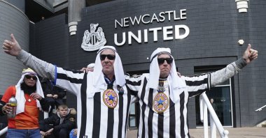 Newcastle fans pose for a photo outside the ground before an English Premier League soccer match between Newcastle and Tottenham Hotspur at St. James' Park in Newcastle, England, Oct. 17, 2021. (AP Photo)