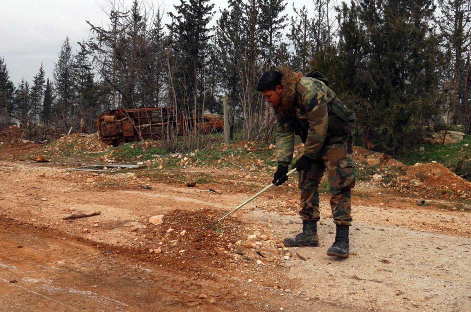 In this photo released by the Syrian official news agency SANA, a Syrian engineering soldier checks for mines in the M5 highway, recaptured by Bashar Assad's forces in Aleppo, Syria, Saturday, Feb. 15, 2020. (AP File Photo)
