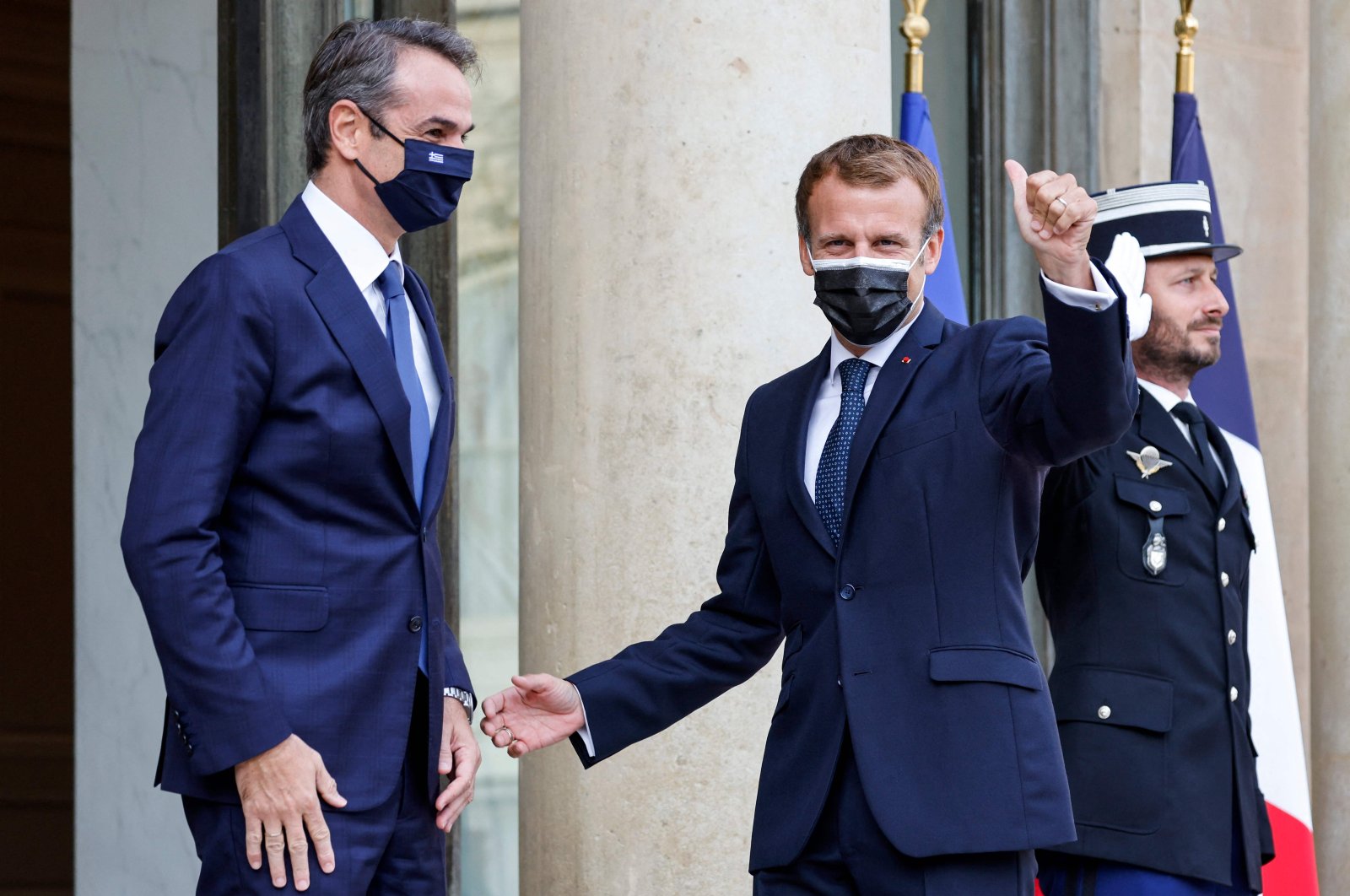 French President Emmanuel Macron (R) and Greek Prime Minister Kyriakos Mitsotakis gesture prior to the signing ceremony of a new defense deal at The Elysee Palace in Paris, France, Sept. 28, 2021. (AFP Photo)