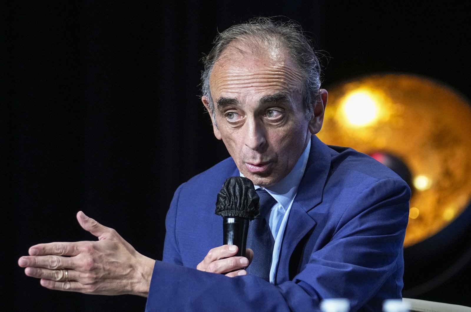 Hard-right political talk-show star Eric Zemmour gestures as he talks during a meeting to promote his latest book "La France n'a pas dit son dernier mot" (France has not yet said its last word) in Versailles, west of Paris, France, Oct. 19, 2021. (AP Photo)