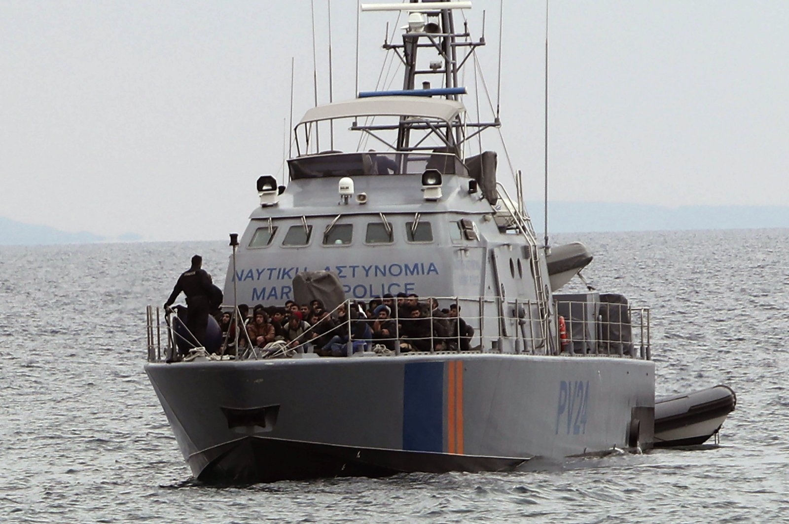 Migrants aboard a Greek Cypriot administration police patrol boat as they are brought to a harbor after being rescued from their own vessel off the Mediterranean island nation's southeastern coast of Protaras, Eastern Mediterranean, Jan. 14, 2020. (AP File Photo)