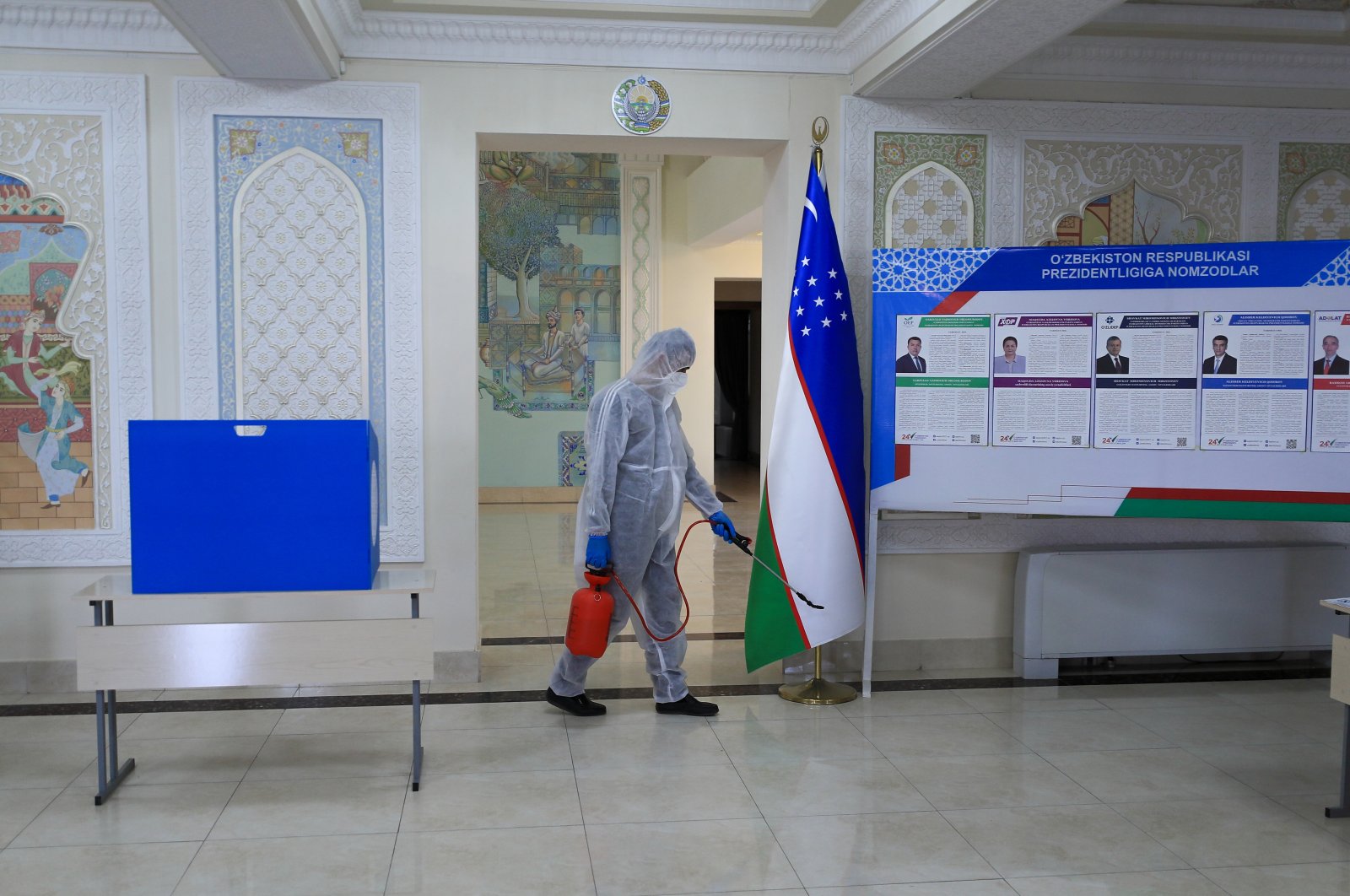 A worker disinfects a polling station ahead of the upcoming 2021 Uzbekistan presidential election scheduled for October 24, Samarkand, Uzbekistan, Oct. 20, 2021. (Reuters Photo)