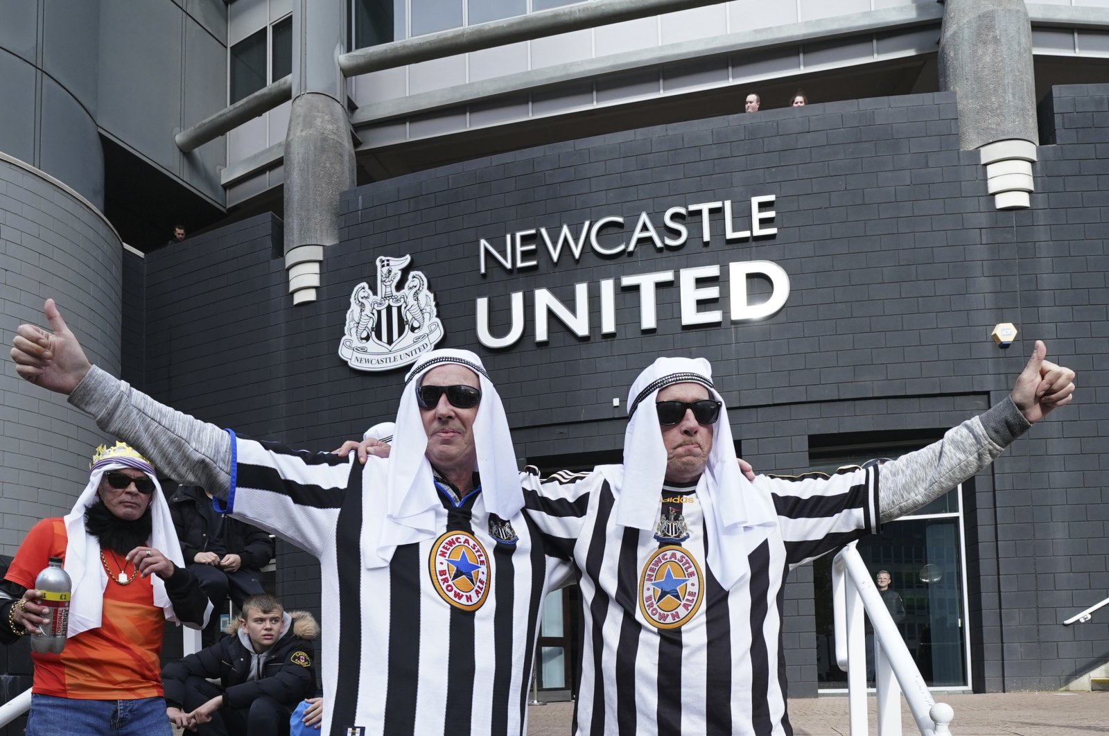 Newcastle fans pose for a photo outside the ground before an English Premier League soccer match between Newcastle and Tottenham Hotspur at St. James' Park in Newcastle, England, Oct. 17, 2021. (AP Photo)