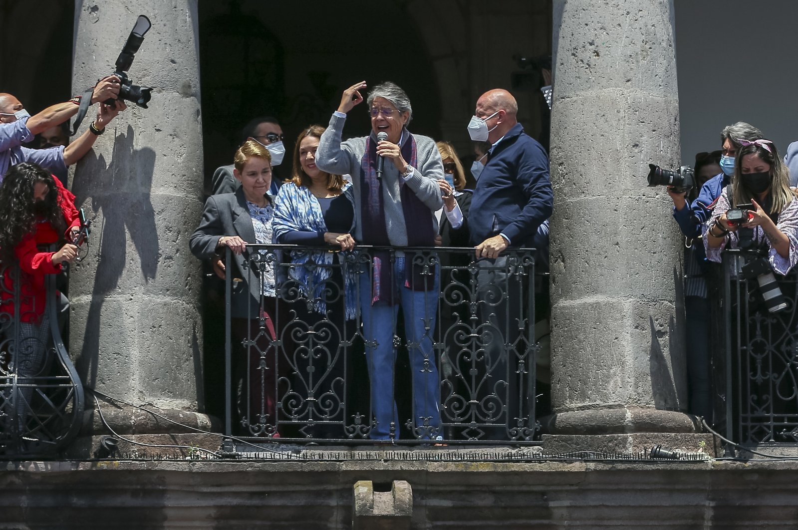 The president of Ecuador, Guillermo Lasso (C), along with his wife Maria de Lourdes Alcivar (L), and his vice president, Alfredo Borrero (R), talk to supporters from a balcony of the government palace, in Quito, Ecuador, Oct. 20, 2021. (EPA Photo)