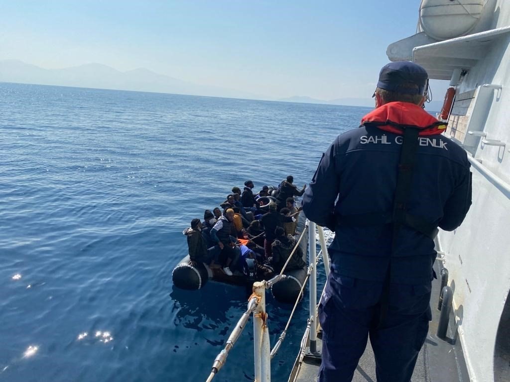 A Turkish Coast Guard Command officer oversees the rescue of irregular migrants, in the Kuşadası district of Aydın, Turkey, Oct. 20, 2021. (AA Photo)