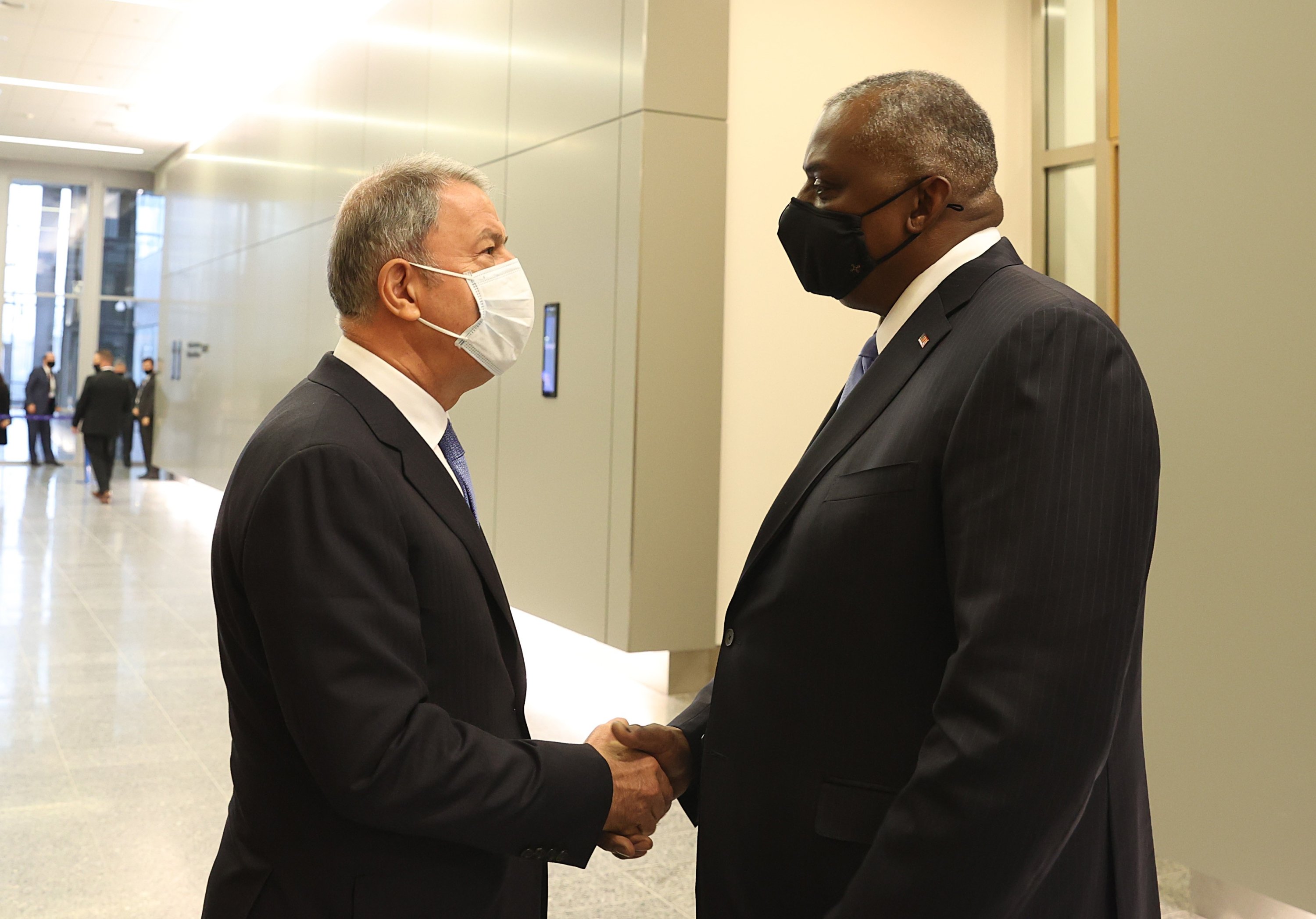 Defense Minister Akar and his U.S. counterpart Lloyd Austin shake hands on the sidelines of the NATO Ministers of Defense meeting in Brussels, Oct. 21, 2021 (IHA Photo)