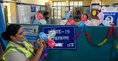 Volunteers decorate a vaccination center to celebrate India administering its billionth COVID-19 vaccine against the coronavirus at a health center in New Delhi, India, Oct. 21, 2021. (AFP Photo)