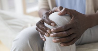 A person holds their knee. (Getty Images)