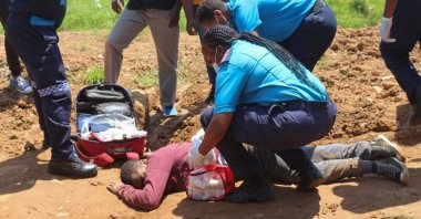 Paramedics tend to a person who was injured by police during protests in Mbabane, Eswatini, Oct. 20, 2021. (AFP Photo)