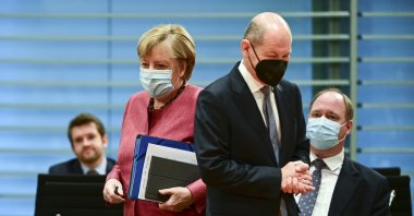 German Chancellor Angela Merkel (front L) and German Finance Minister and Vice-Chancellor Olaf Scholz (front R) arrive for the weekly cabinet meeting at the Chancellery in Berlin, Germany, Wednesday, Oct. 20, 2021. (AP Photo)