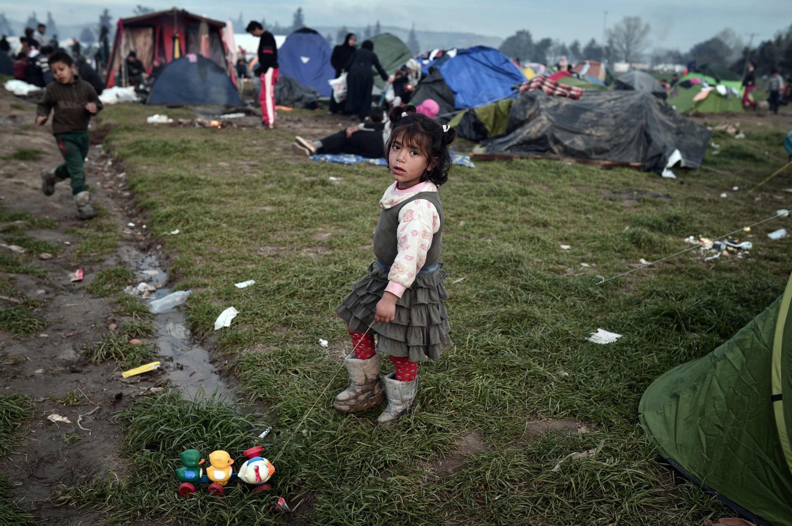 A child plays at a makeshift camp at the Greek-Macedonian borders, where the "Balkan route" once carried thousands of refugees to Europe, near the village of Idomeni, Greece, March 8, 2016. (AFP)