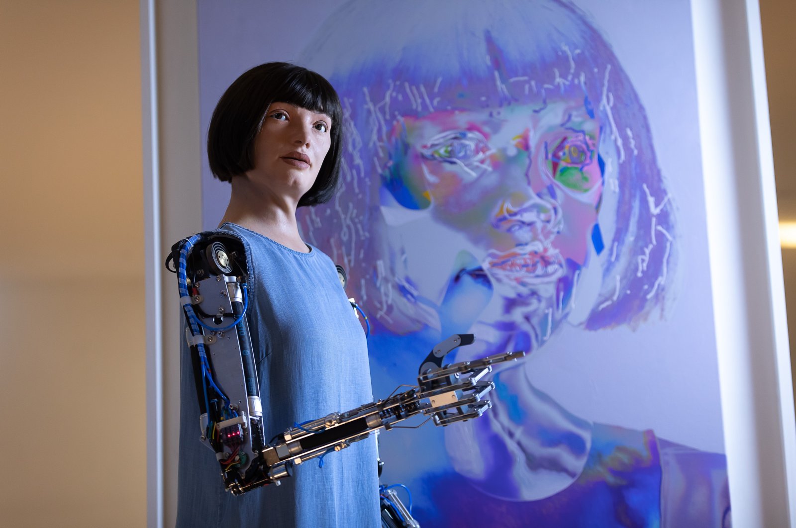 Ai-Da stands in front of one of "her" artworks during "Ai-Da: The World's First Robot Artist" press view at Design Museum in London, U.K., May 18, 2021. 
(Getty Images)