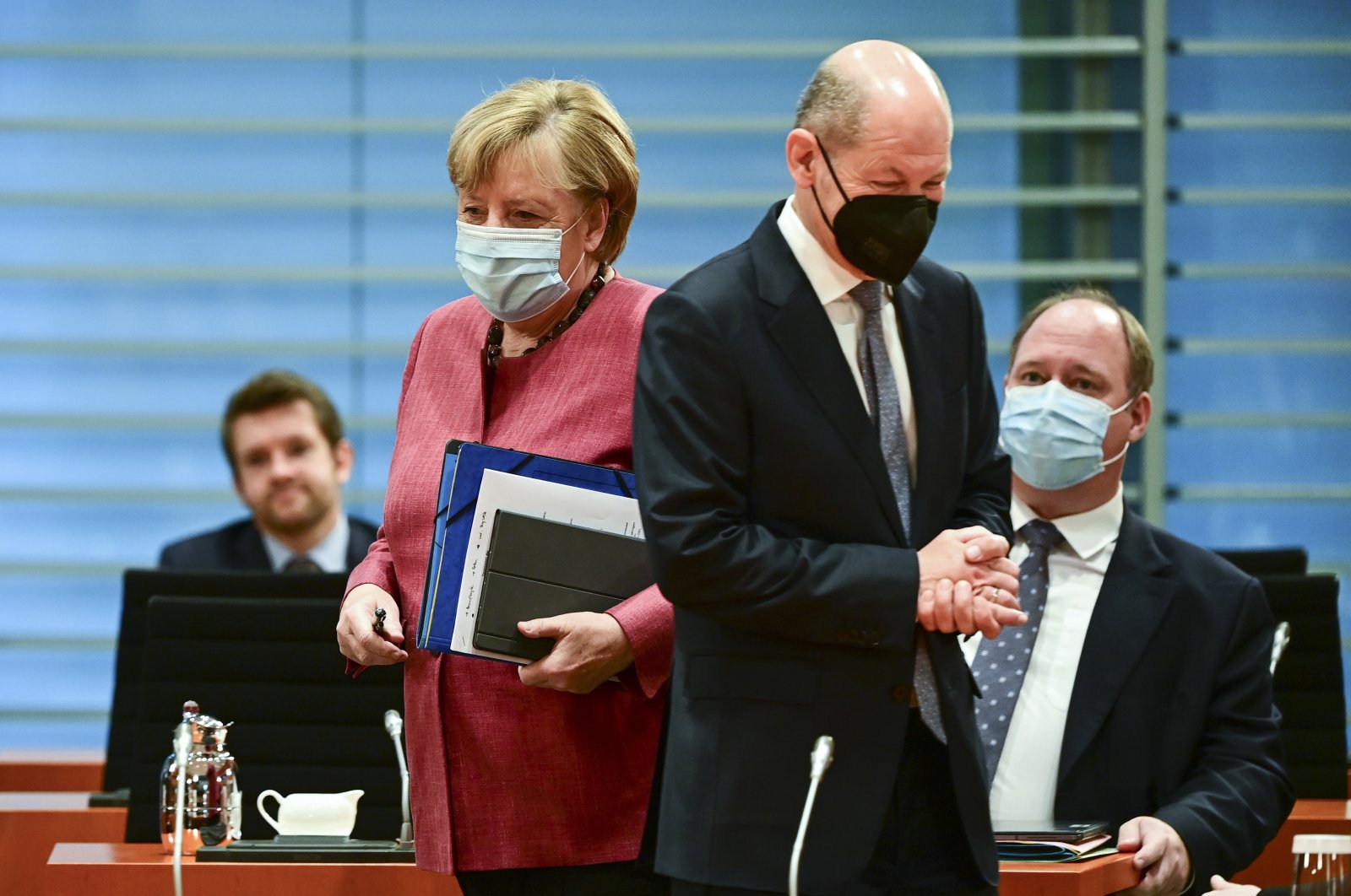 German Chancellor Angela Merkel (front L) and German Finance Minister and Vice-Chancellor Olaf Scholz (front R) arrive for the weekly cabinet meeting at the Chancellery in Berlin, Germany, Wednesday, Oct. 20, 2021. (AP Photo)