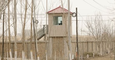 A security person watches from a guard tower around a detention facility in Yarkent county in northwestern China's Xinjiang Uyghur Autonomous Region, March 21, 2021. (AP Photo)