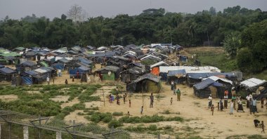 Rohingya refugees gather near their shelters in the "no man's land" behind Myanmar's border lined with barbed wire fences in the Maungdaw district, Rakhine state bordered by Bangladesh, April 25, 2018. (AFP Photo)
