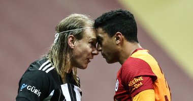 Beşiktaş's Domagoj Vida (L) and Galatasaray's Mostafa Mohamed try to stare each other down during a Süper Lig match at the Türk Telekom Arena, in Istanbul, Turkey, May 8, 2021. (AA Photo)
