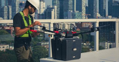 A technician checks Unither Bioelectronique's drone for its historic flight in Toronto, Canada, in this handout photo released by Unither Bioelectronique taken in September 2021. (Unither Bioelectronique via AFP)