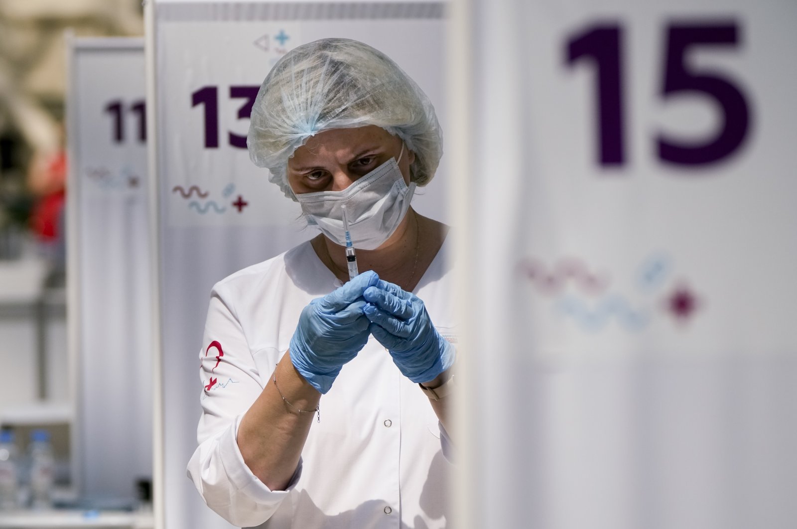 A medical worker prepares an injection of Russia's Sputnik V coronavirus vaccine at a vaccination center in Gostiny Dvor a huge exhibition place in Moscow, Russia, July 13, 2021. (AP Photo)
