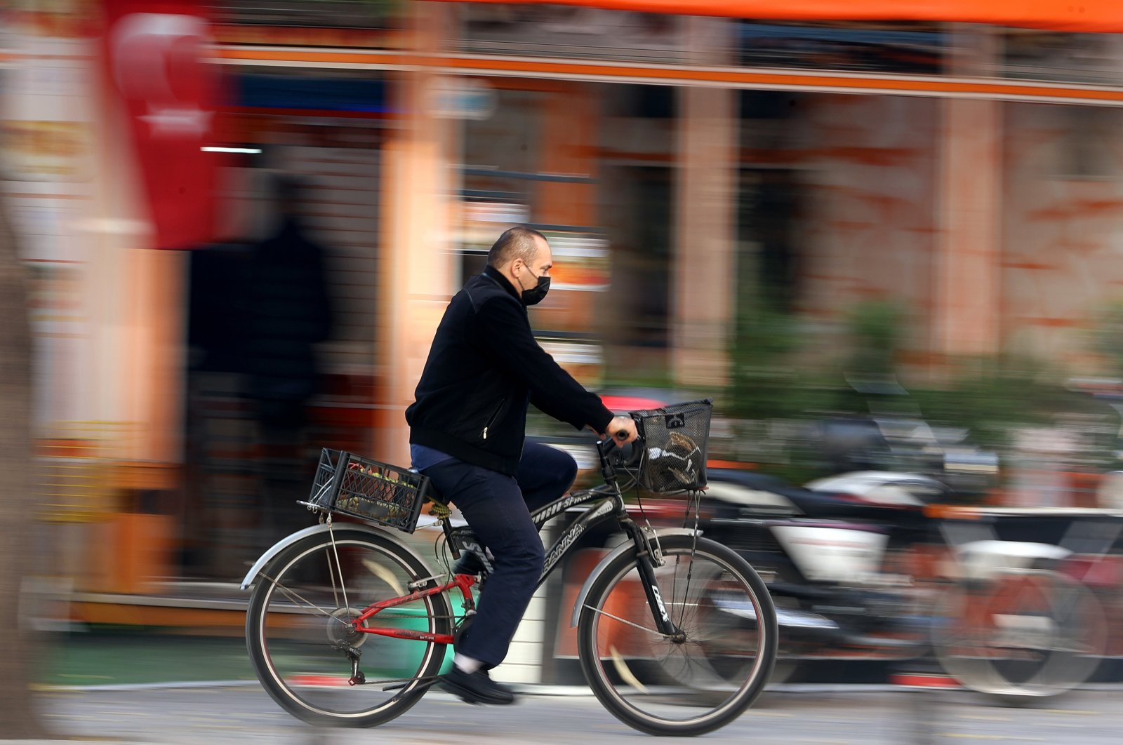 A man rides a bicycle on a street, in Konya, central Turkey, Oct. 22, 2021. (AA PHOTO) 
