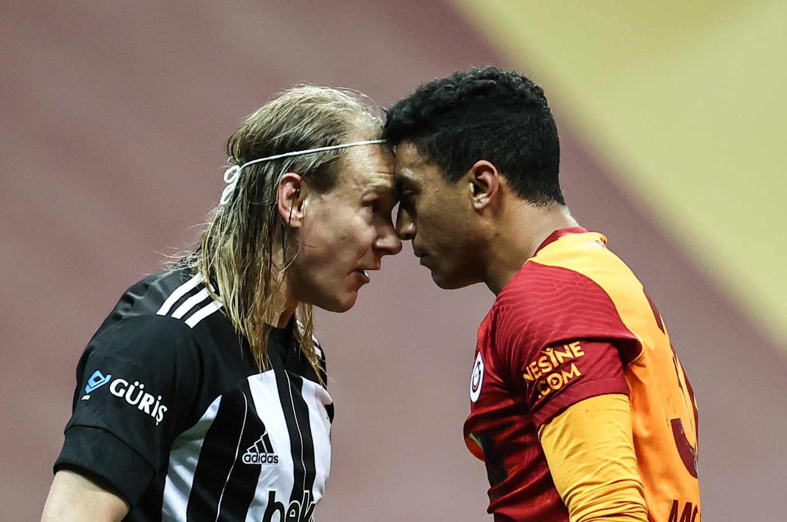 Beşiktaş's Domagoj Vida (L) and Galatasaray's Mostafa Mohamed try to stare each other down during a Süper Lig match at the Türk Telekom Arena, in Istanbul, Turkey, May 8, 2021. (AA Photo)