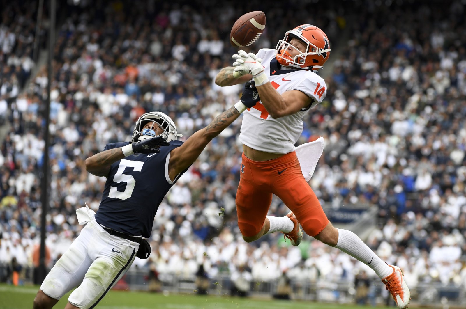 Penn State cornerback Tariq Castro-Fields (5) breaks up a pass intended for Illinois wide receiver Casey Washington (14) during the second half, State College, Pennsylvania, U.S., Oct. 23, 2021. (AP Photo)