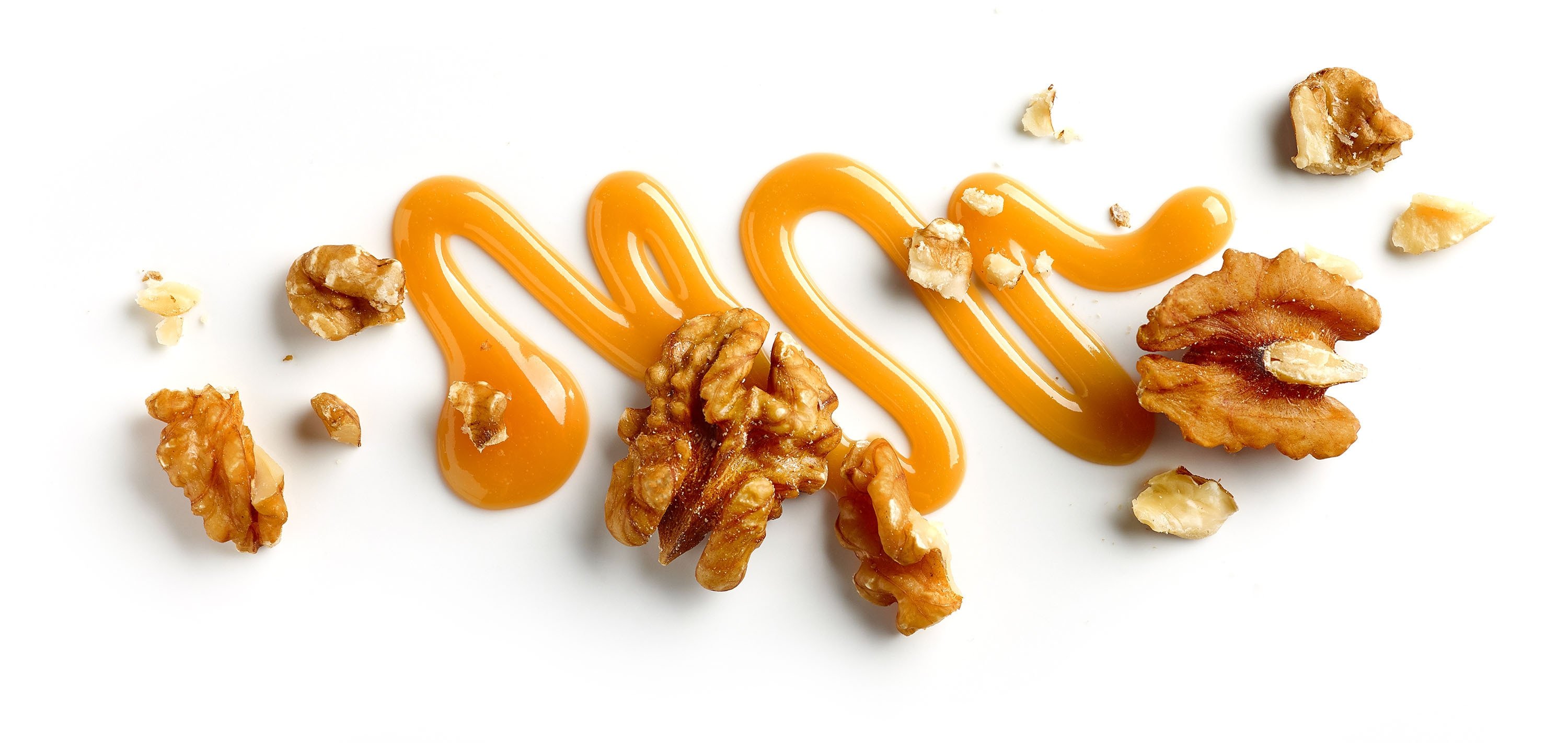 Caramel sauce sprinkled among walnuts. (Shutterstock Photo)