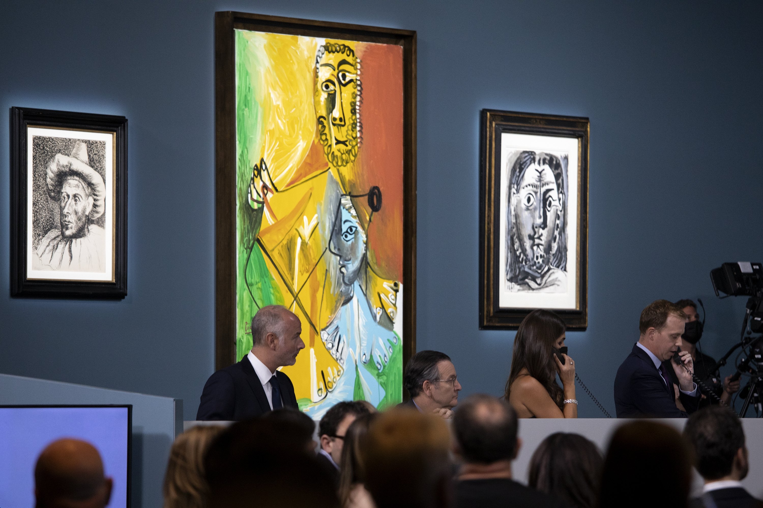 Buyers and attendees mingle during an auction of Pablo Picasso