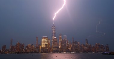 Lightning strikes One World Trade Center during a thunderstorm over lower Manhattan as the sun sets in New York City, U.S., July 6, 2021. (Photo by Getty Images)