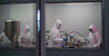 Scientists re-enact the calibration procedure of equipment at an Afrigen Biologics and Vaccines facility in Cape Town, South Africa, Oct. 19, 2021. (AP Photo)