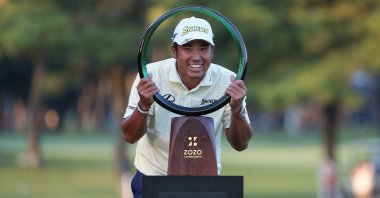 Japan's Hideki Matsuyama poses with the trophy after winning the PGA ZOZO Championship golf tournament at the Narashino Country Club in Inzai, Chiba prefecture, Japan, Oct. 24, 2021. (AFP Photo)