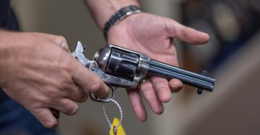 Props expert Guillaume Delouche at Independent Studio Services holds a prop gun while talking about them in Sunland-Tujunga, Los Angeles, California, U.S., Oct. 22, 2021. (AFP Photo)
