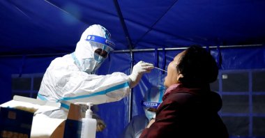 A resident undergoes a nucleic acid test for COVID-19 in Zhangye in China's northwestern Gansu province, Oct. 21, 2021. (AFP Photo)