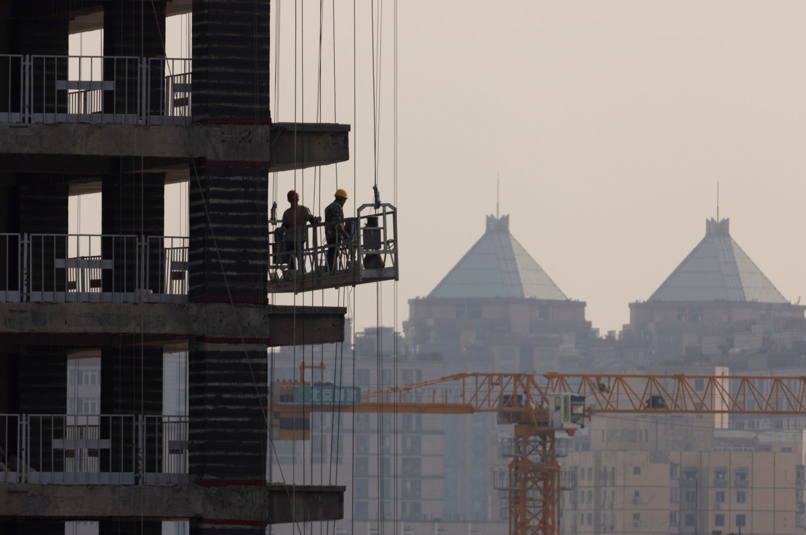 Men work at the construction site of a highrise building in Beijing, China, Oct. 18, 2021. (Reuters Photo)