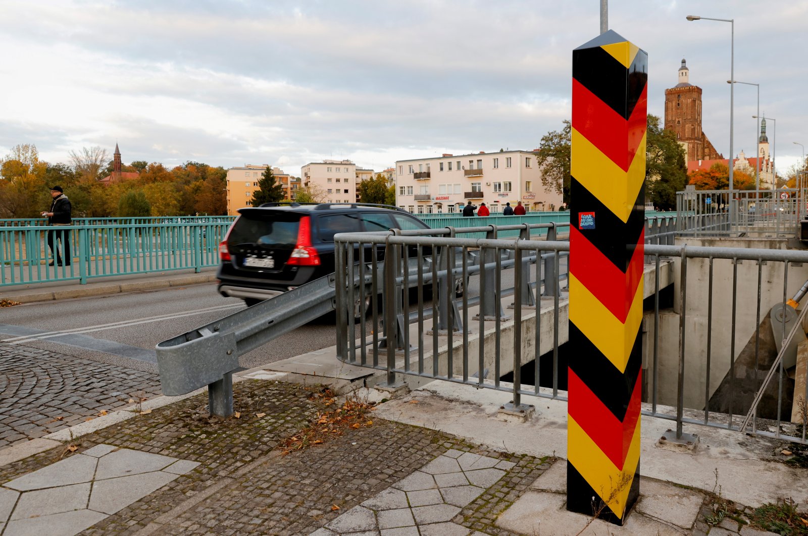 People cross the border between Germany and Poland in Guben, Germany, October 23, 2021.     (Reuters Photo)