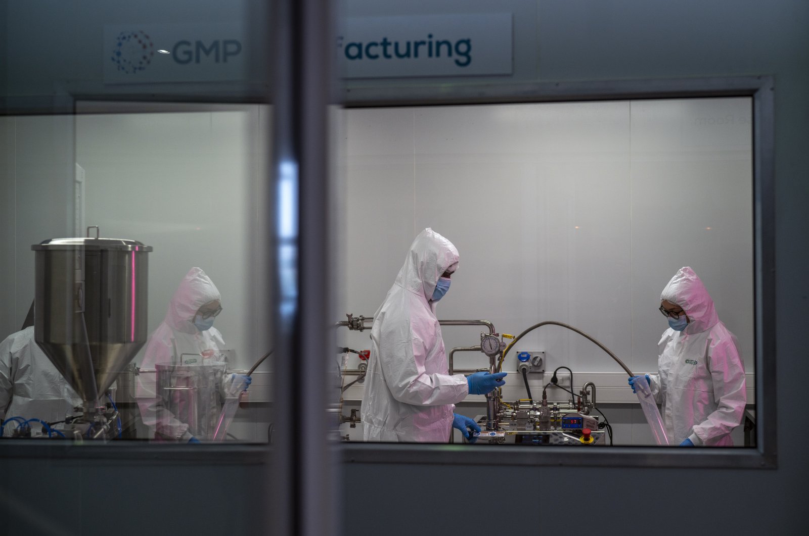 Scientists re-enact the calibration procedure of equipment at an Afrigen Biologics and Vaccines facility in Cape Town, South Africa, Oct. 19, 2021. (AP Photo)