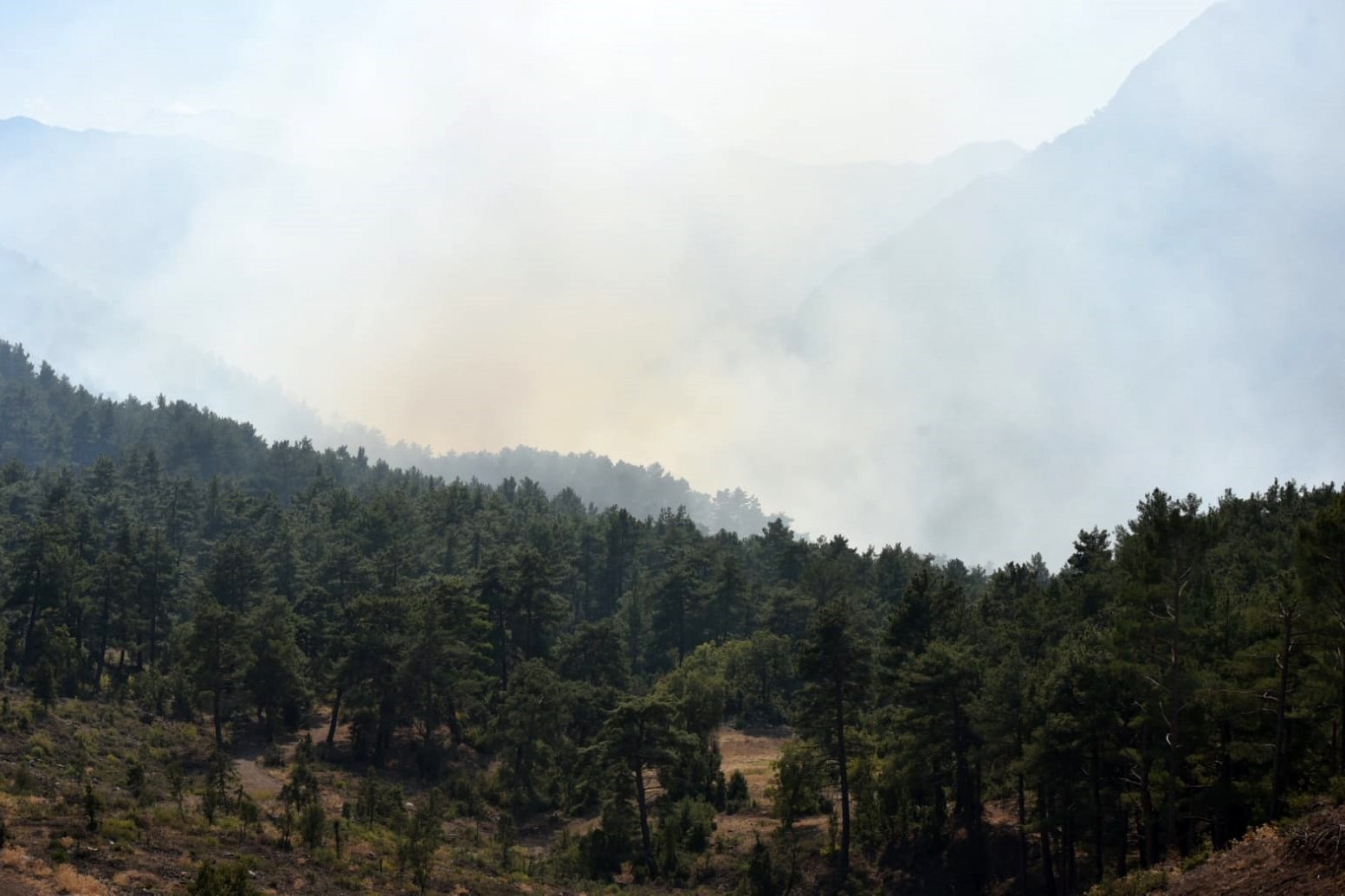 Smoke rising from a burning forest in Konyaaltı district, in Antalya, southern Turkey, Oct. 23, 2021. (DHA Photo)