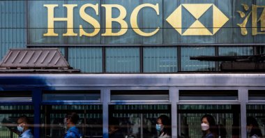 People commute on a tram past the HSBC bank headquarters in Hong Kong, Oct. 25, 2021. (AFP Photo)